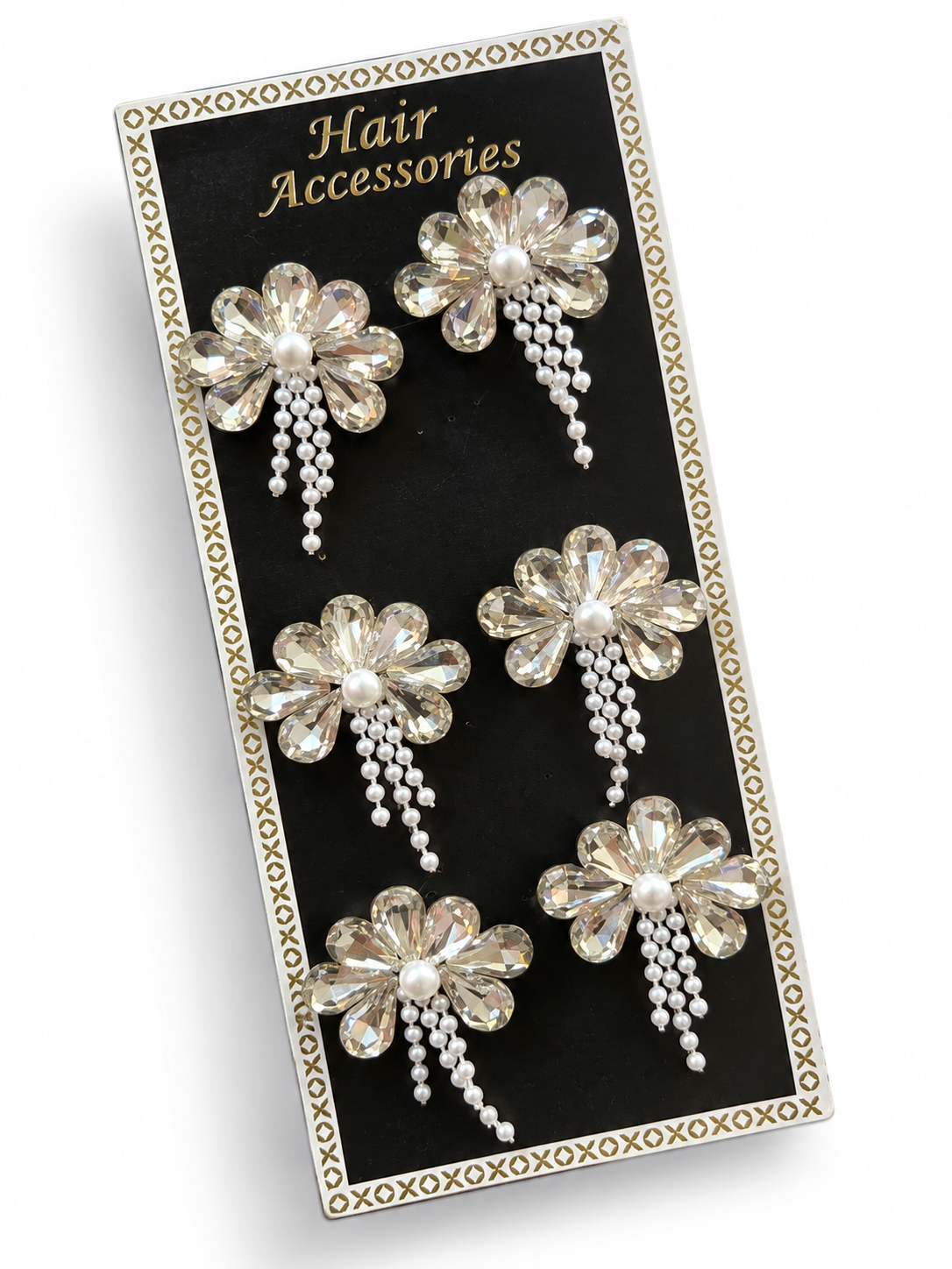 Clear crystal flower hair stickers with pearl centres displayed on a black card