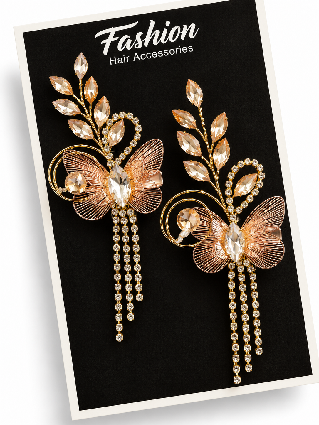 Pair of gold butterfly crystal hair clips with dangling rhinestone chains on display card