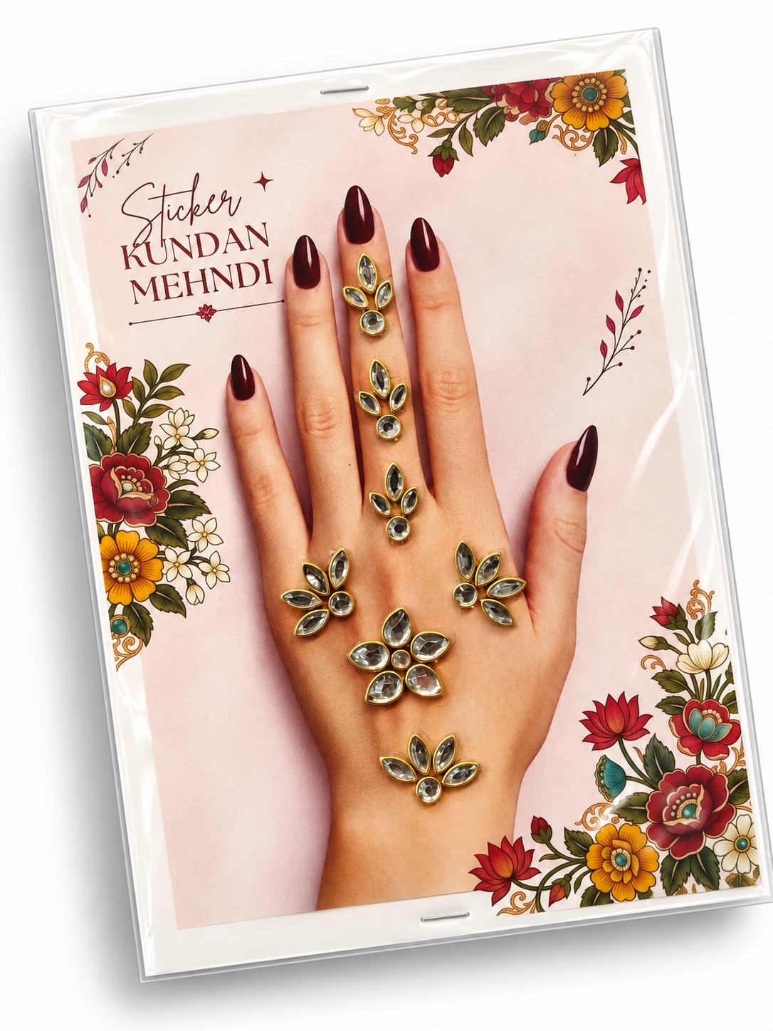 Kundan mehndi sticker set with gold-tone teardrop stones and floral hand decorations on a pink floral card