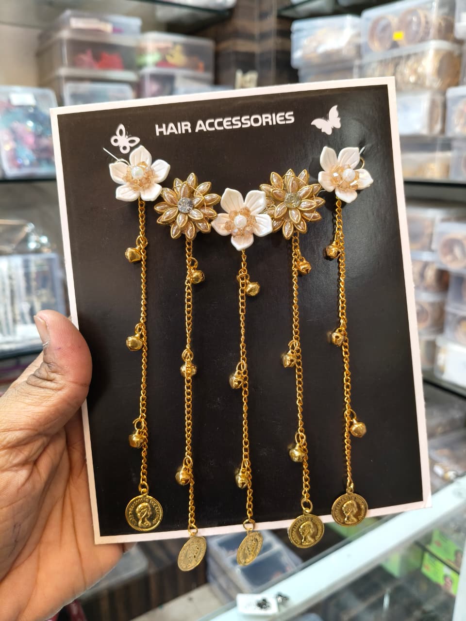 Set of five ivory and gold floral hair ornaments with long gold-tone chains and decorative coin charms
