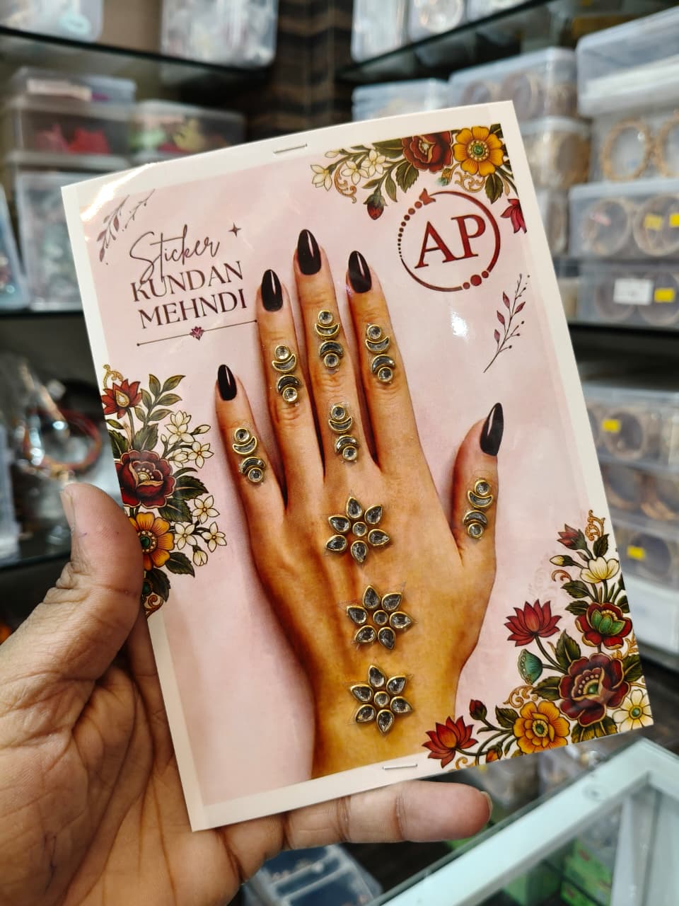 Kundan mehndi decorative stickers with small finger accents and floral hand motifs on a pink card