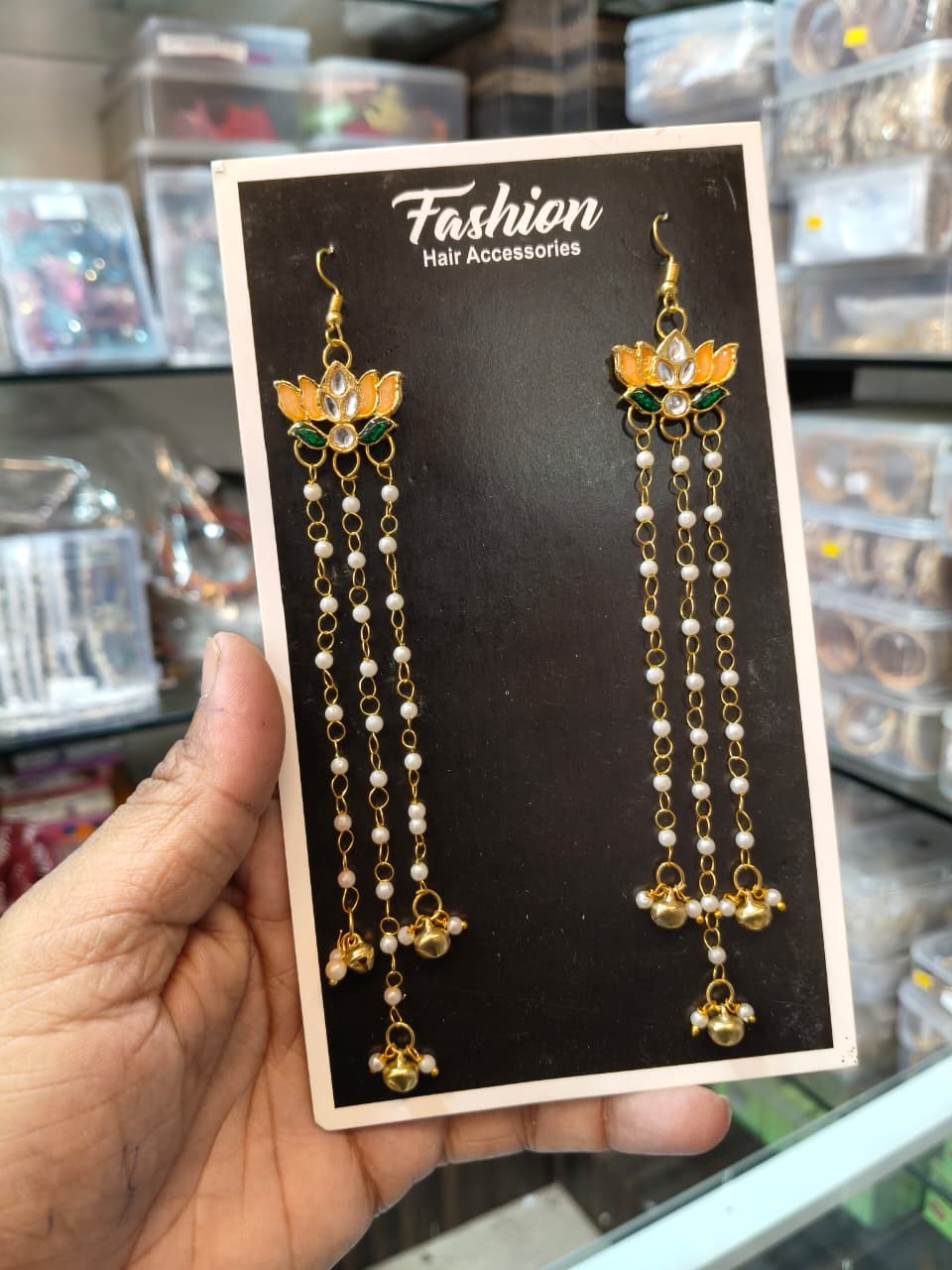 Pair of gold-tone orange lotus hair accessories with pearl strands and dangling gold beads